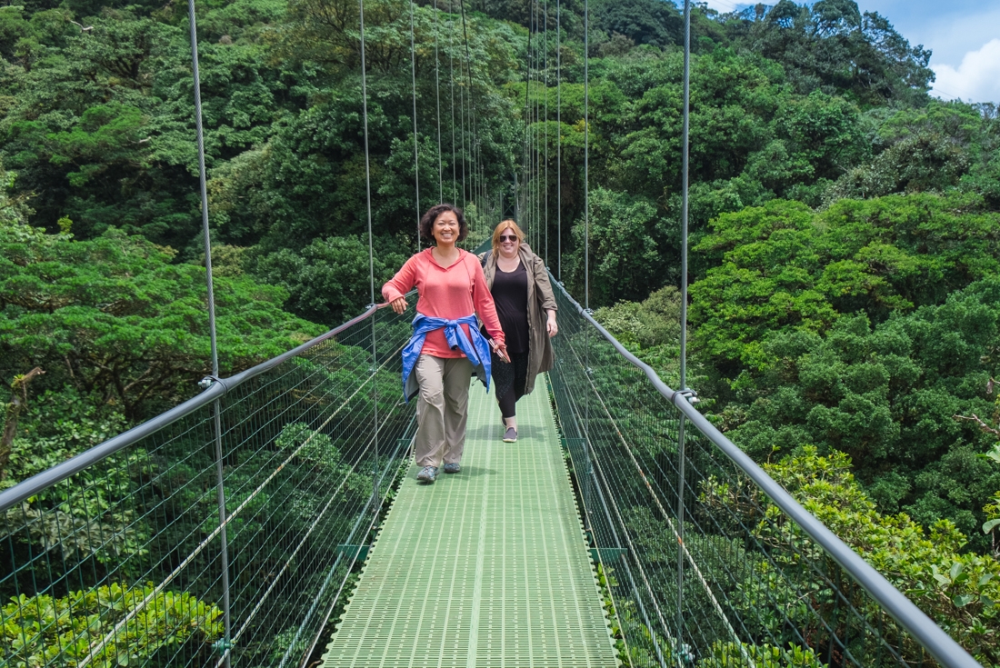 Intrepid travellers emerge from Monteverde cloud forest into the sunlight on a suspension bridge in Costa Rica